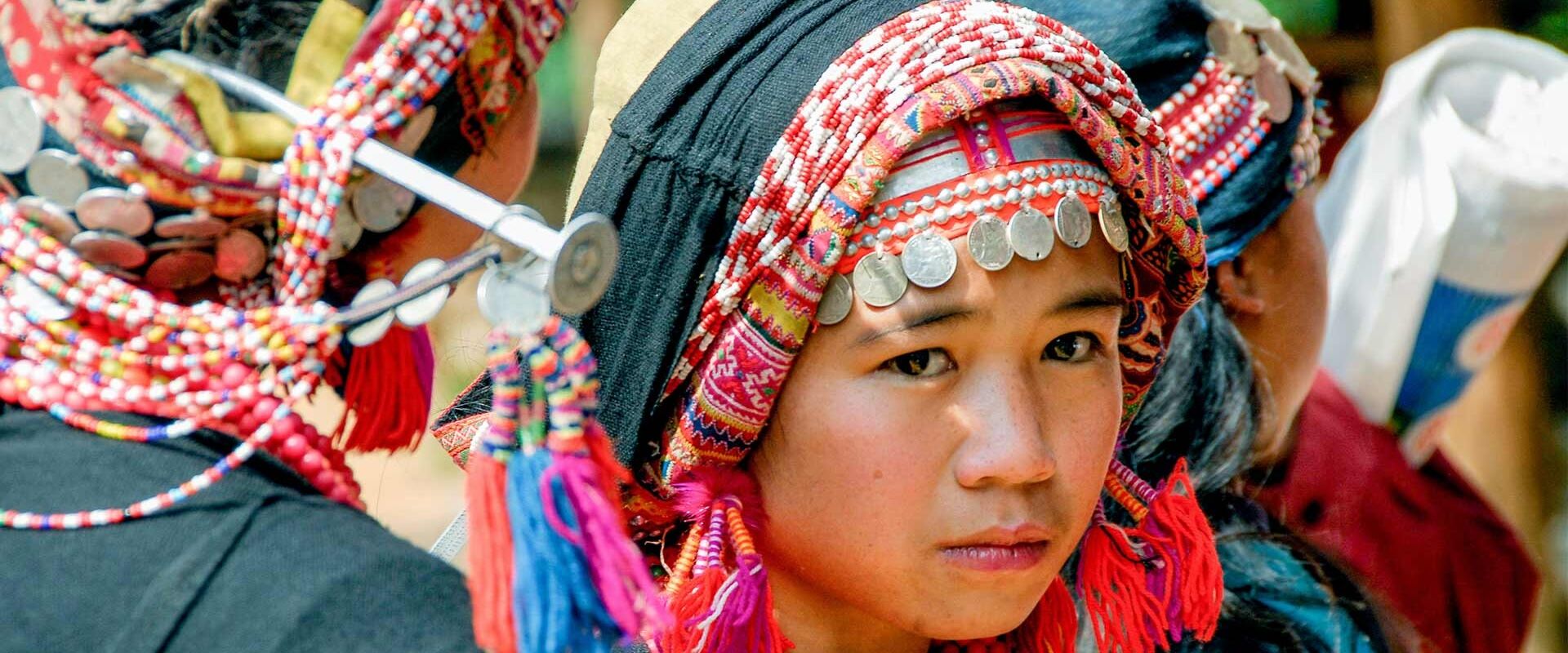 Muang La’s peaceful area with ethnic girl in Laos on a Muang La Travel banner by Legend Travel Group.